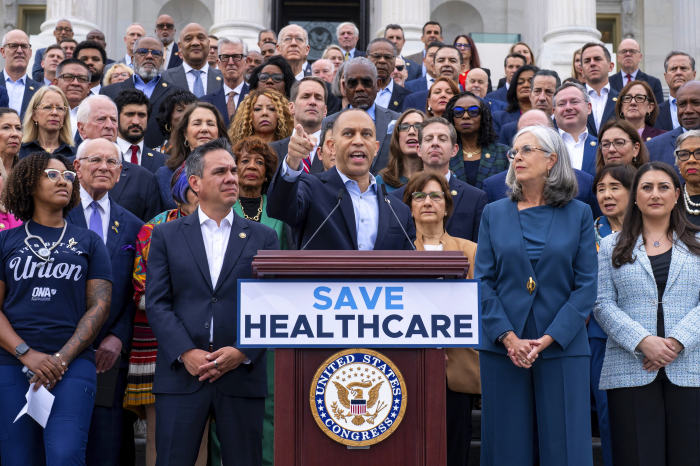 House Minority Leader Hakeem Jeffries speaks at the Capitol with other members of Congress behind them.