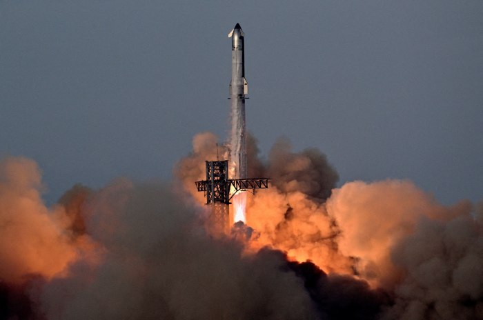 A SpaceX Super Heavy booster carrying the Starship spacecraft lifts off.