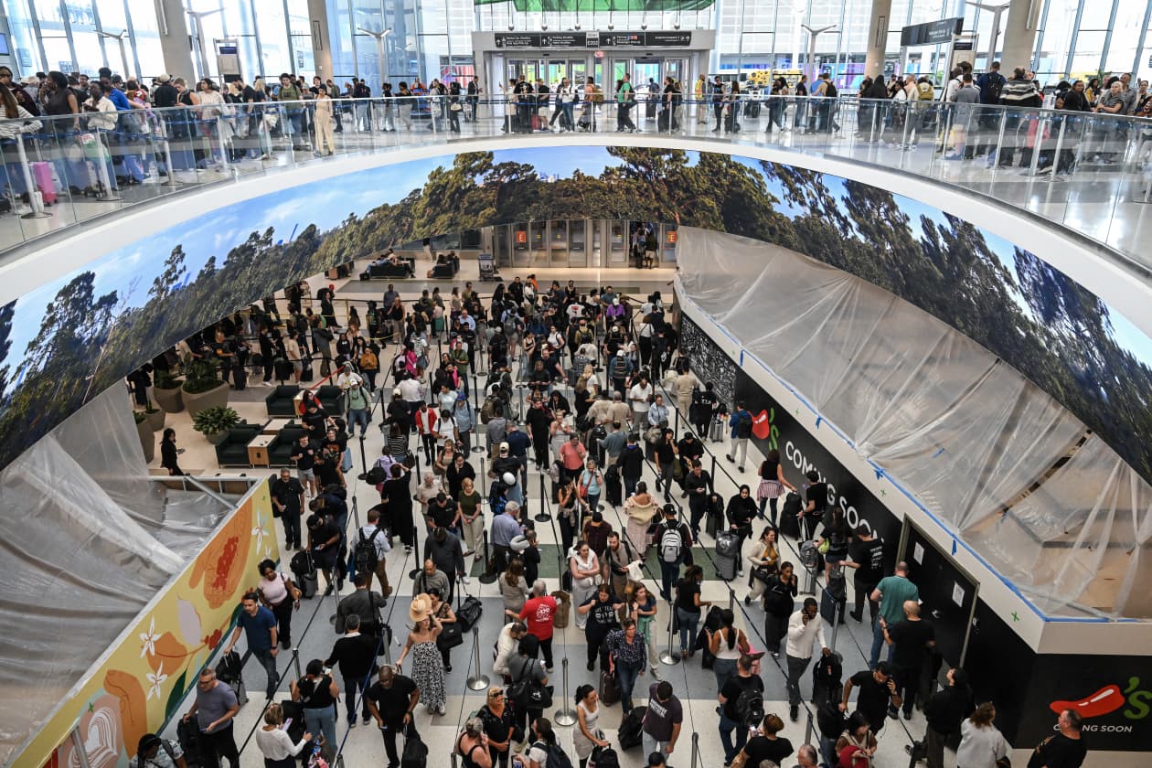 Travelers wait in long security lines at George Bush Intercontinental Airport in Houston.
