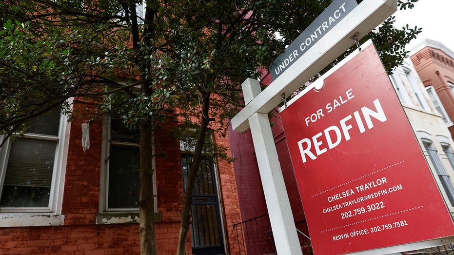 A photo showing a for sale sign in front of a home.