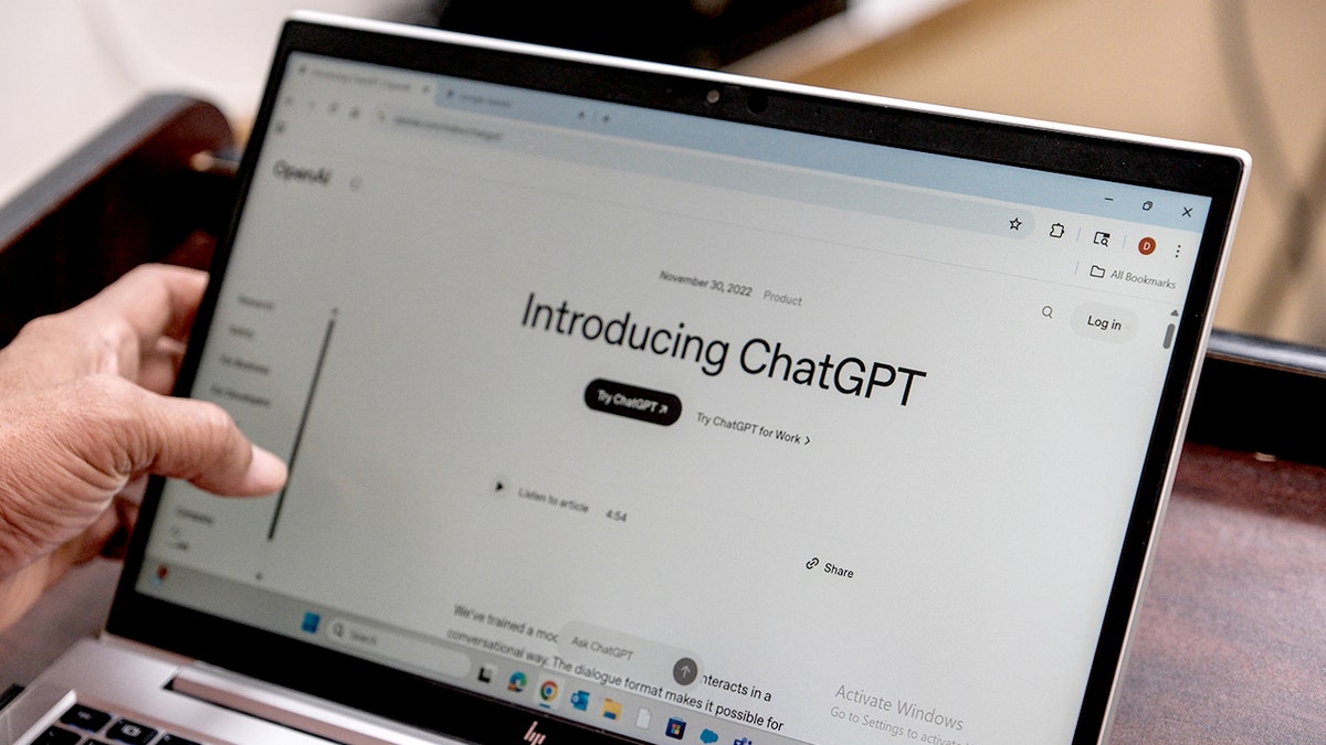A laptop screen reads "Introducing ChatGPT."