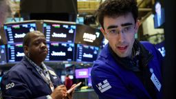 Traders work on the floor at the New York Stock Exchange on Monday. Stocks soared and oil prices fell after President Donald Trump said the United States would postpone strikes on Iran's energy infrastructure.