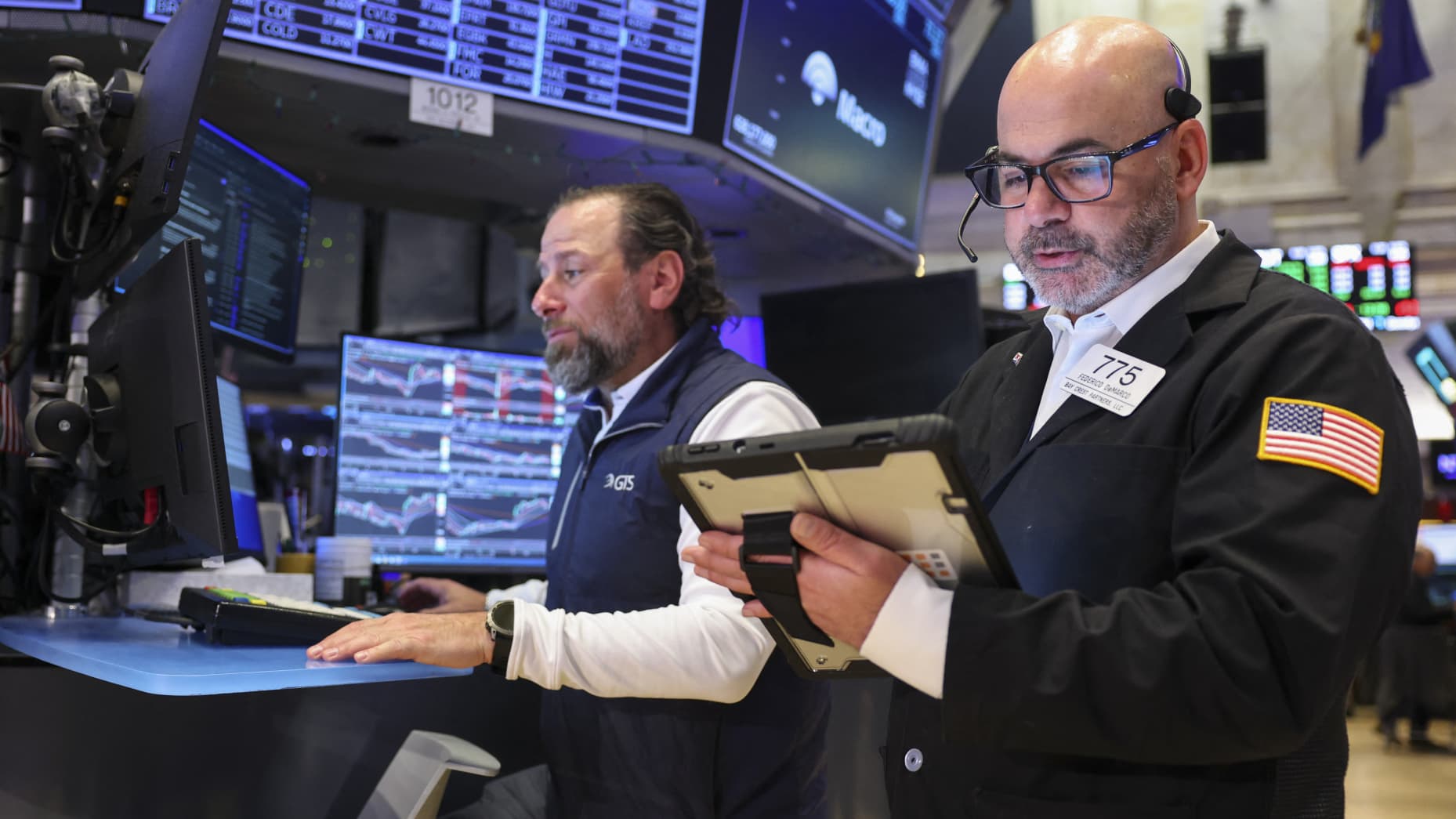 Traders work on the floor of the New York Stock Exchange (NYSE) at the opening bell in New York on March 24, 2026. European and US stocks resumed sliding and oil prices jumped on Tuesday as traders turned cautious over the prospect of a negotiated agreement between the United States and Iran to end the Middle East war. (Photo by ANGELA WEISS / AFP via Getty Images)