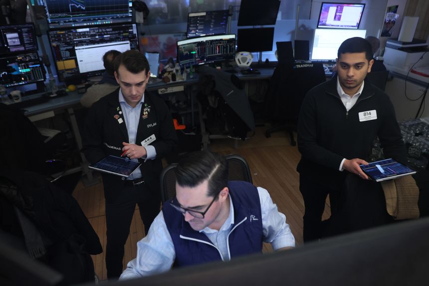 Traders work on the floor of the New York Stock Exchange on February 24 in New York City.