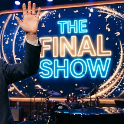 Late night show host speaking and waving on stage during final show